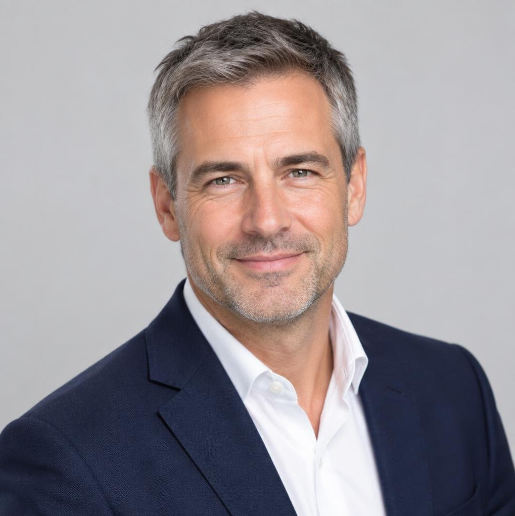 Studio portrait of a man in his forties with short hair and a blazer