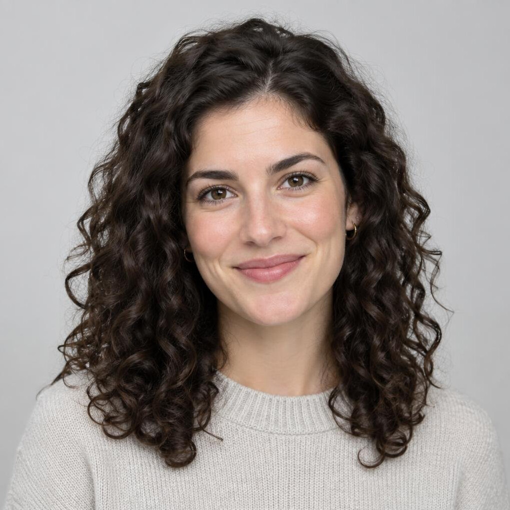 Studio portrait of a woman in her twenties with curly hair