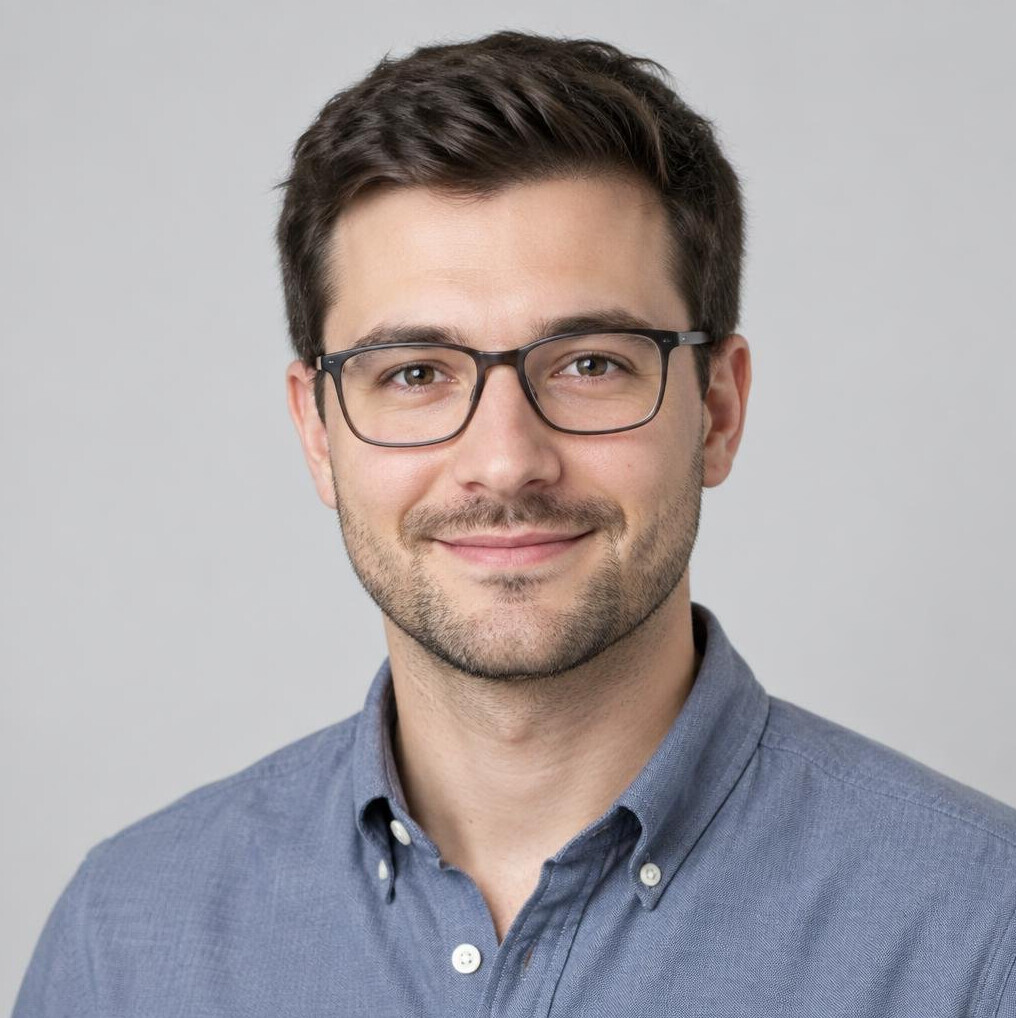 Studio portrait of a young man with glasses and a casual shirt