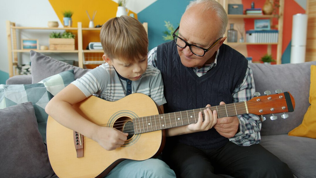 young man playing acoustic guitar